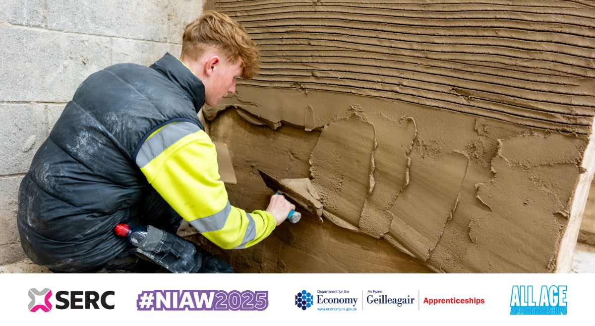 Male student plastering a wall